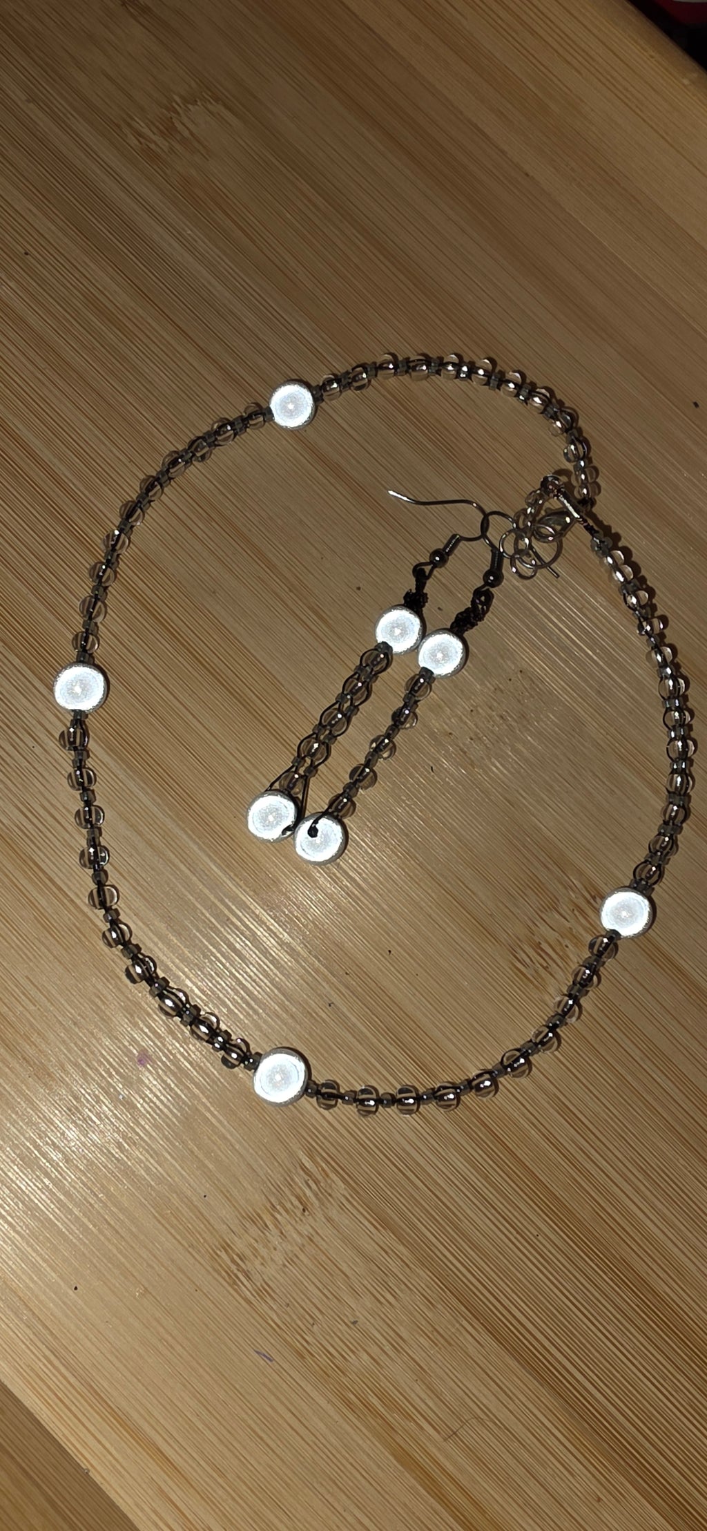 Reflective set of earrings and necklace