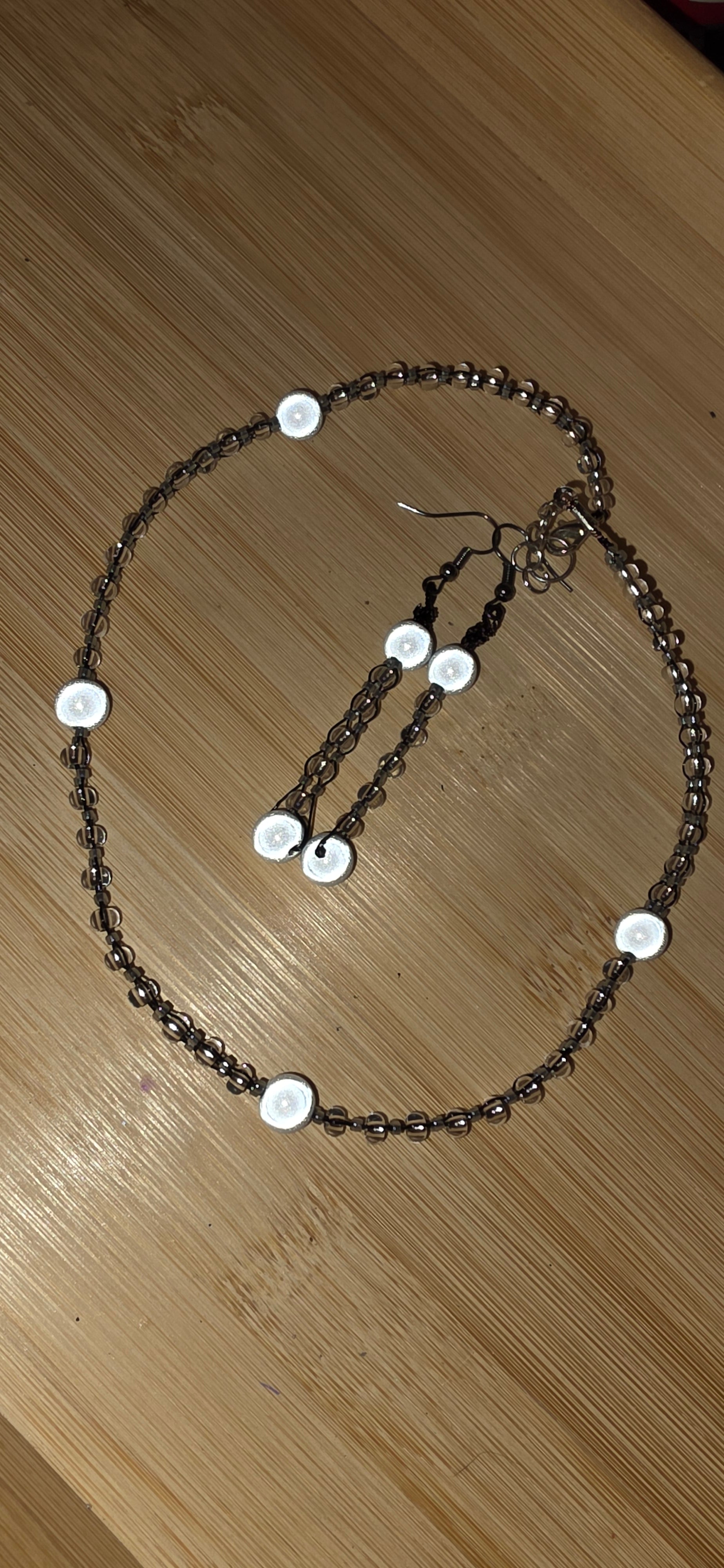 Reflective set of earrings and necklace