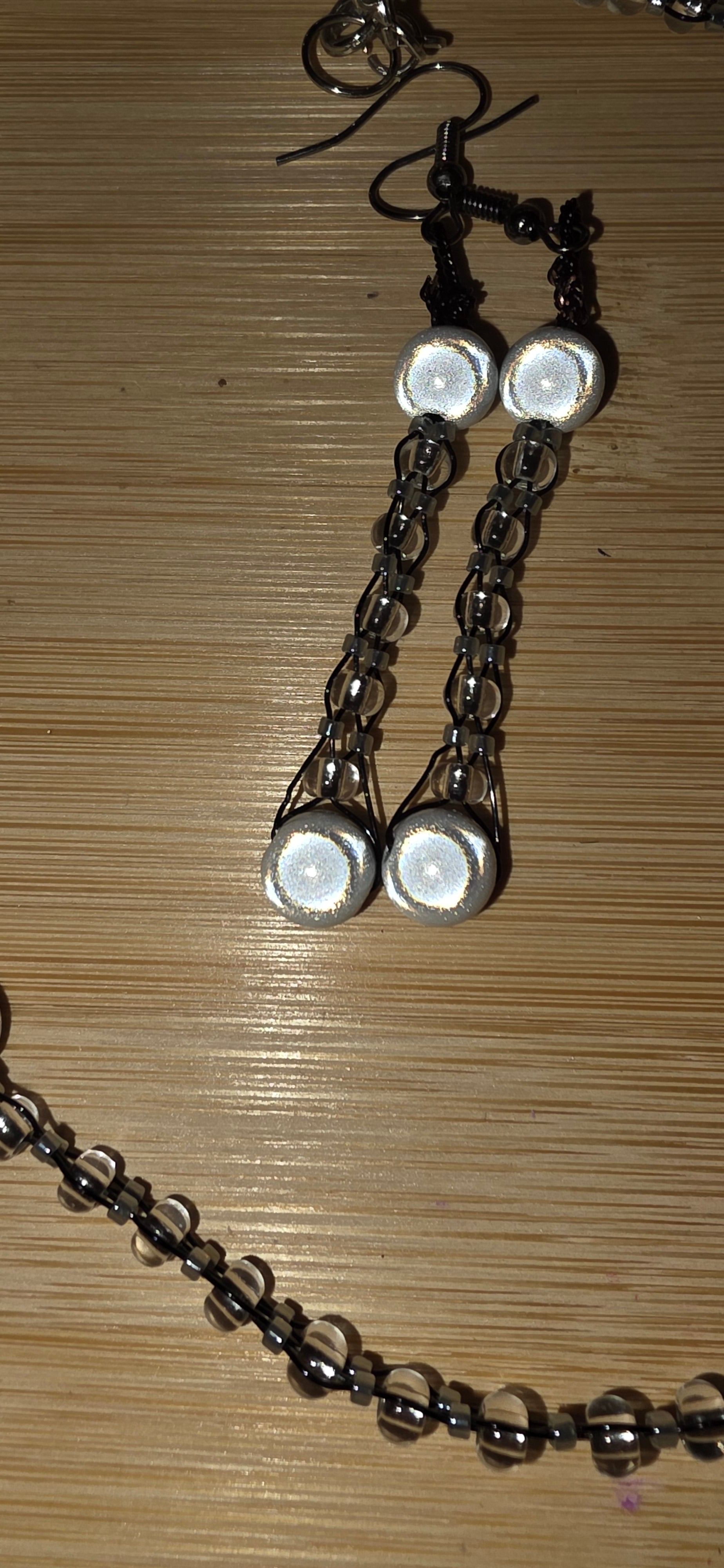 Reflective set of earrings and necklace
