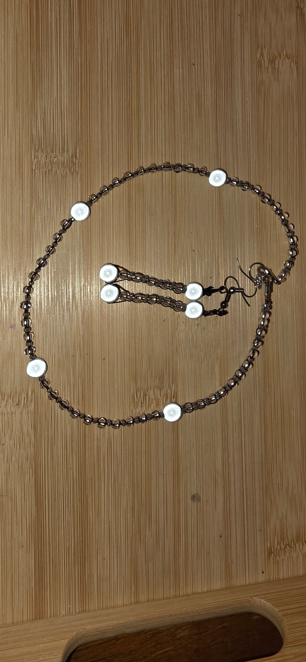 Reflective set of earrings and necklace